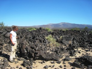 Sample collecting rift basalts with Dabbahu volcano in the background. 
